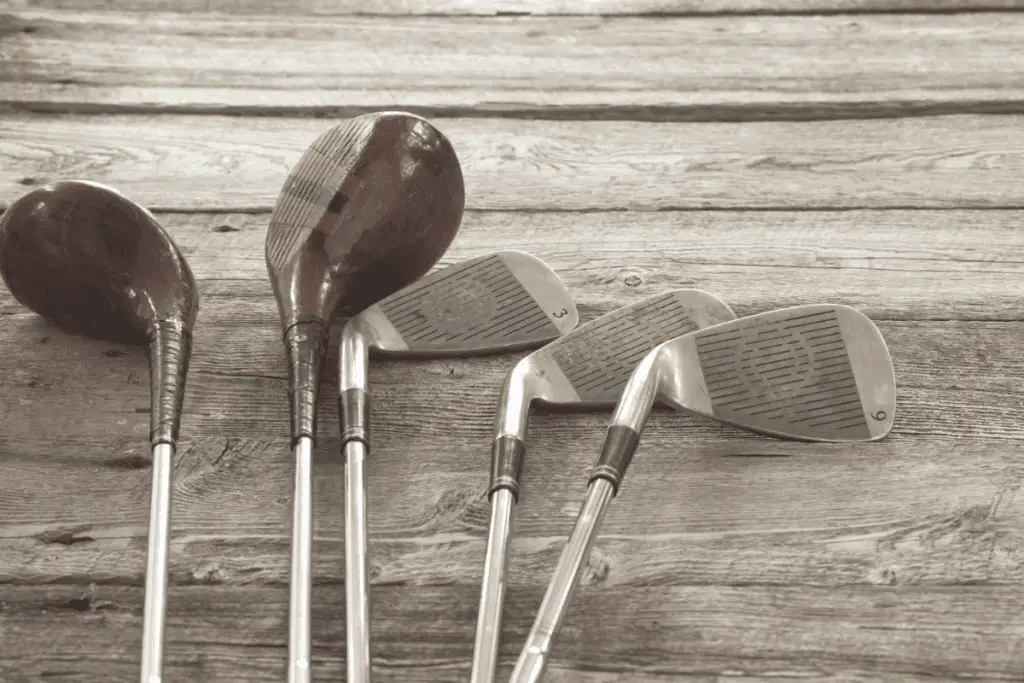 Vintage Golf Clubs on Wood Background