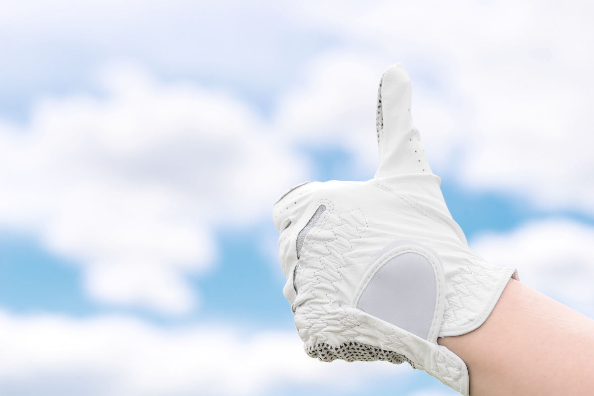 thumbs up gesture with hand in golf a golf glove