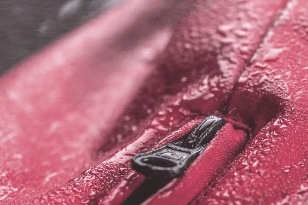 close up picture of red rain jacket zipper