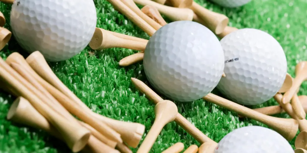 Tees and golf balls on a golf mat