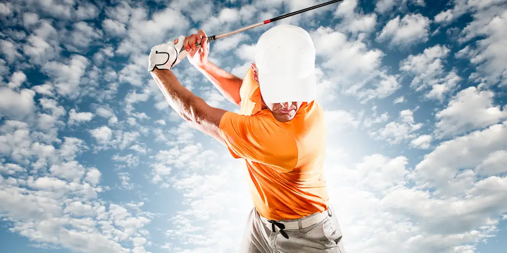 Male golfer at top of backswing