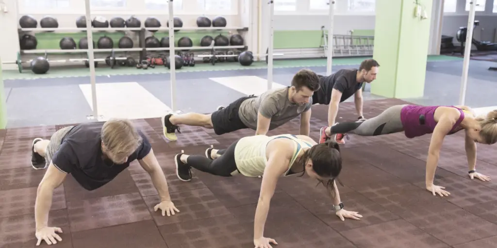 group of people doing pushups